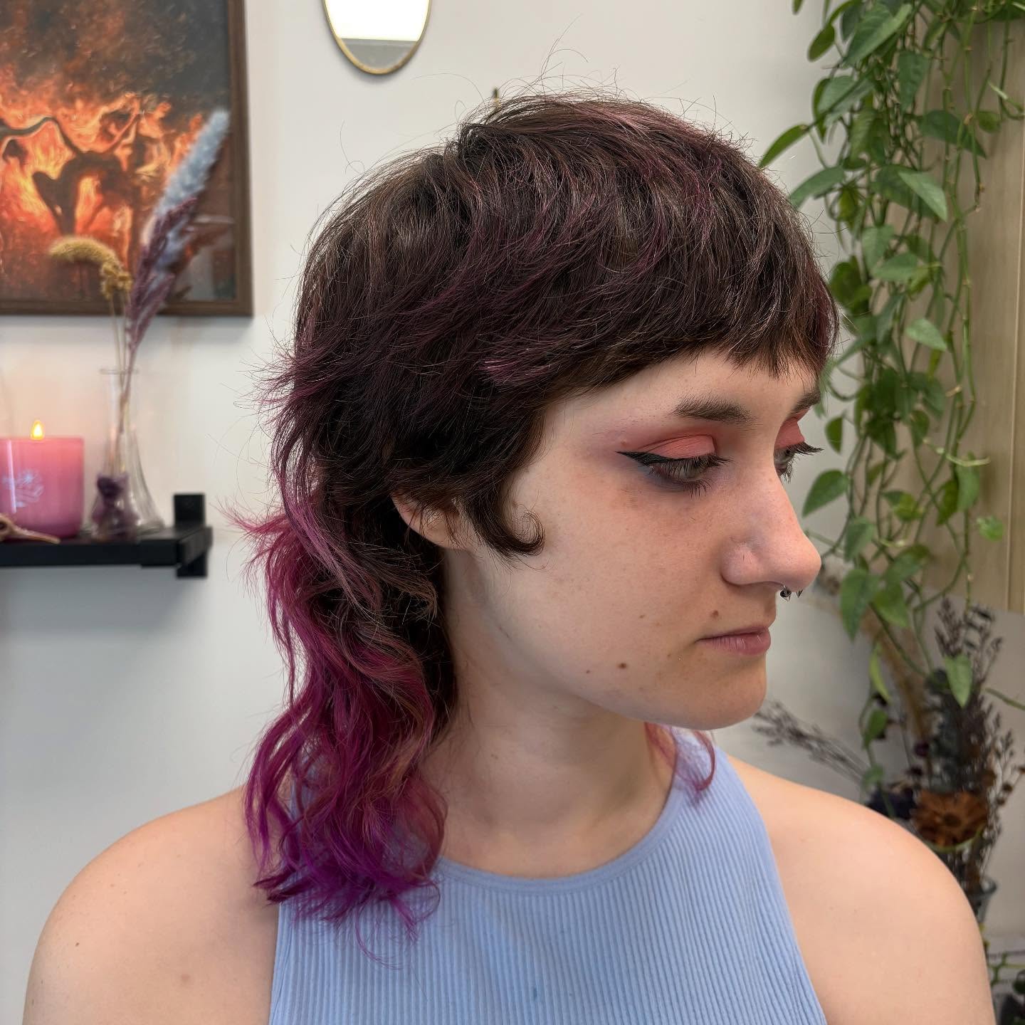 Dark shag mullet with magenta peekaboo ends and a point-cut micro fringe
