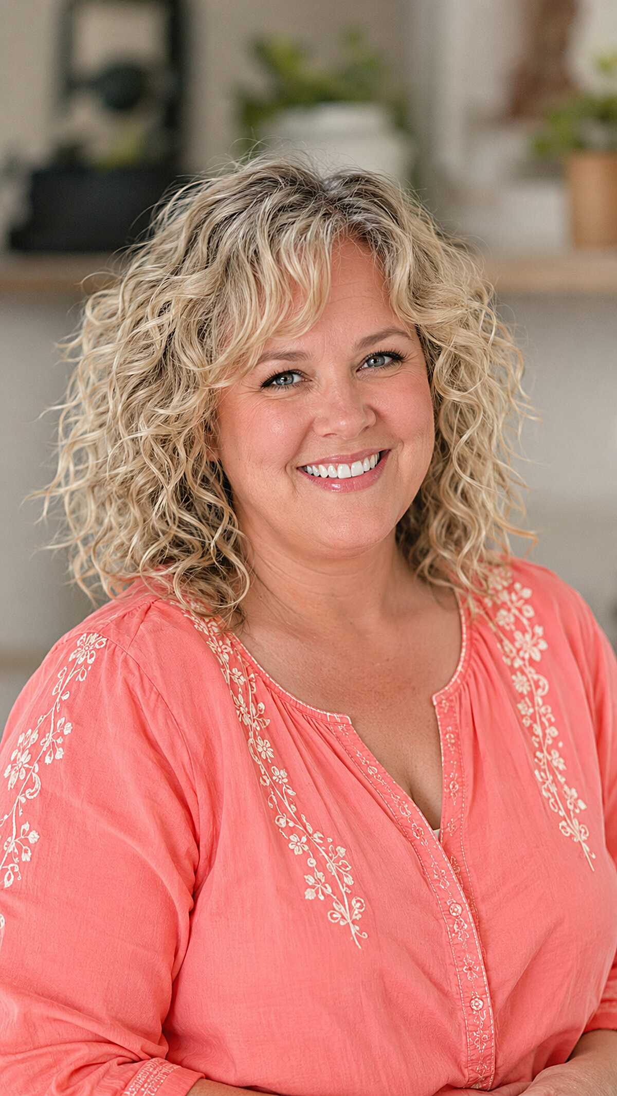 Dimensional blonde curls with full curtain bangs