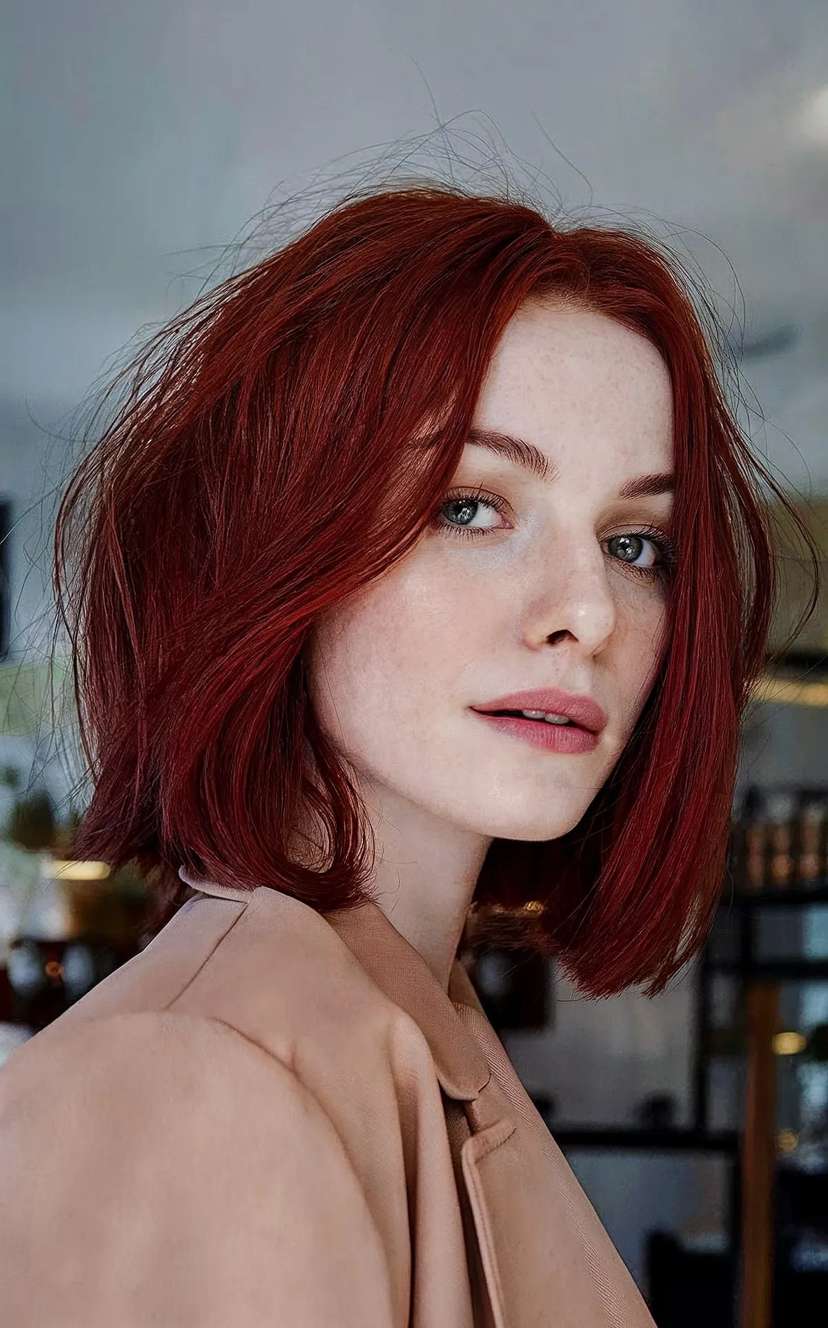 Dark red blunt bob haircut with face-framing layers