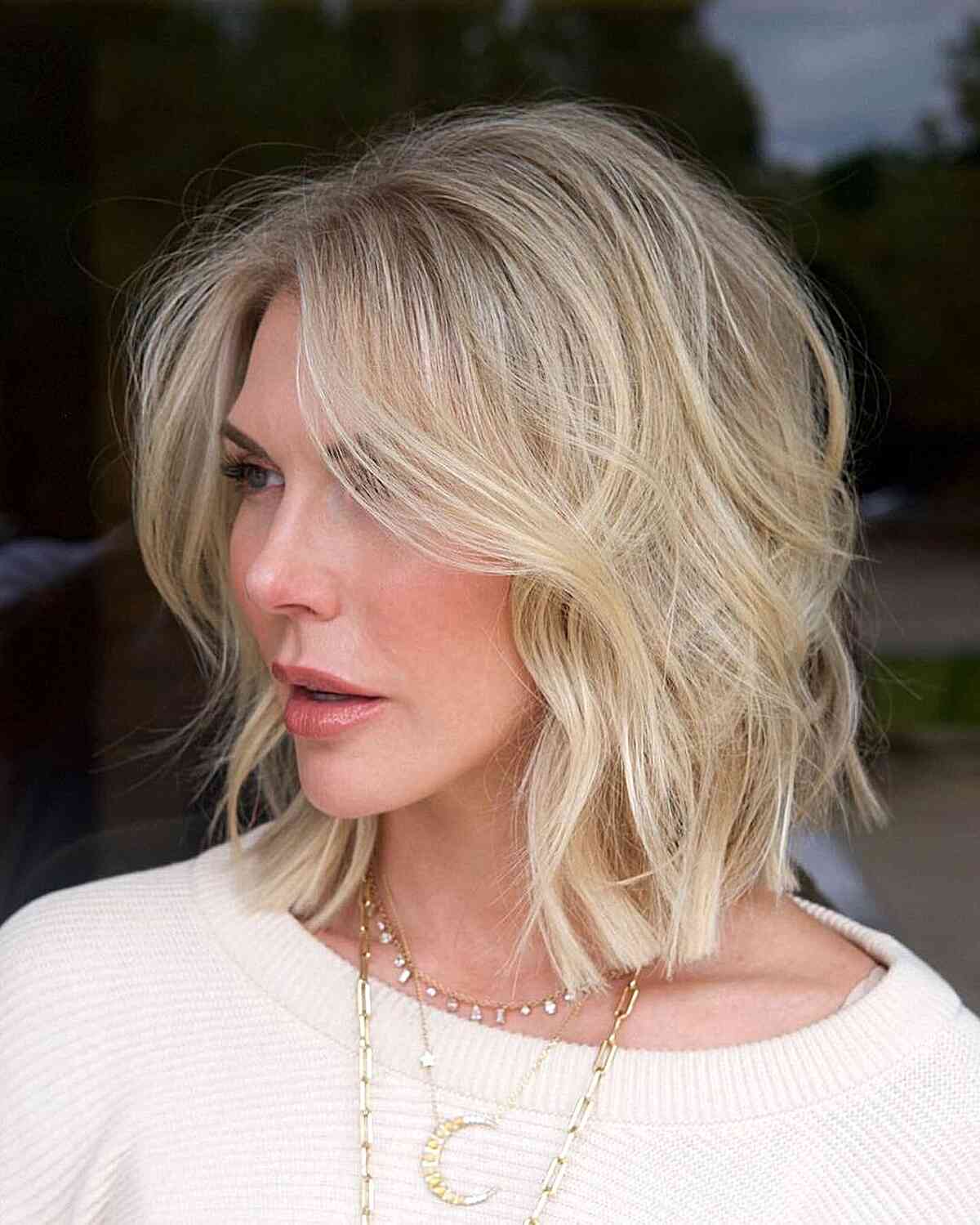 Textured blonde lob with soft face framing highlights