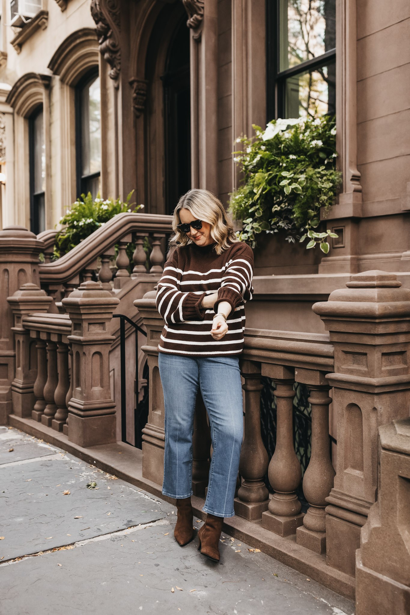 Woman in a chocolate rollneck sweater with jeans and ankle boots LA outfit