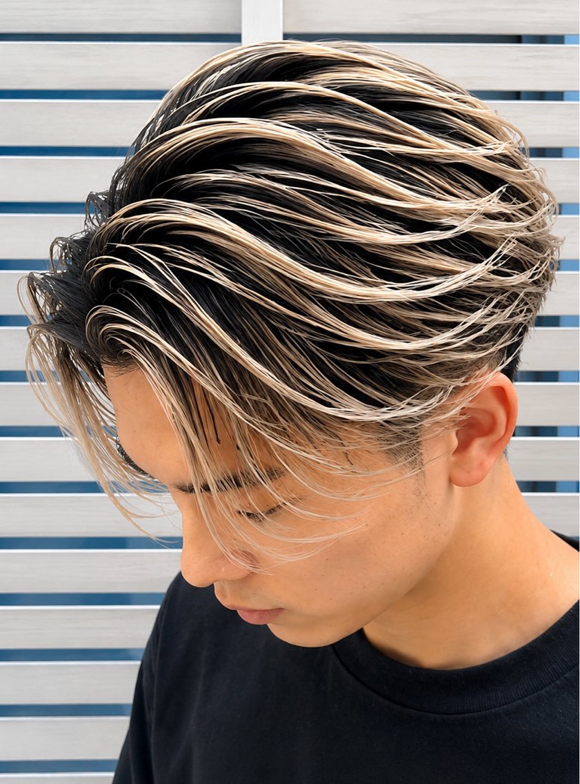 Dark roots fading into ash blonde in a wet-look style