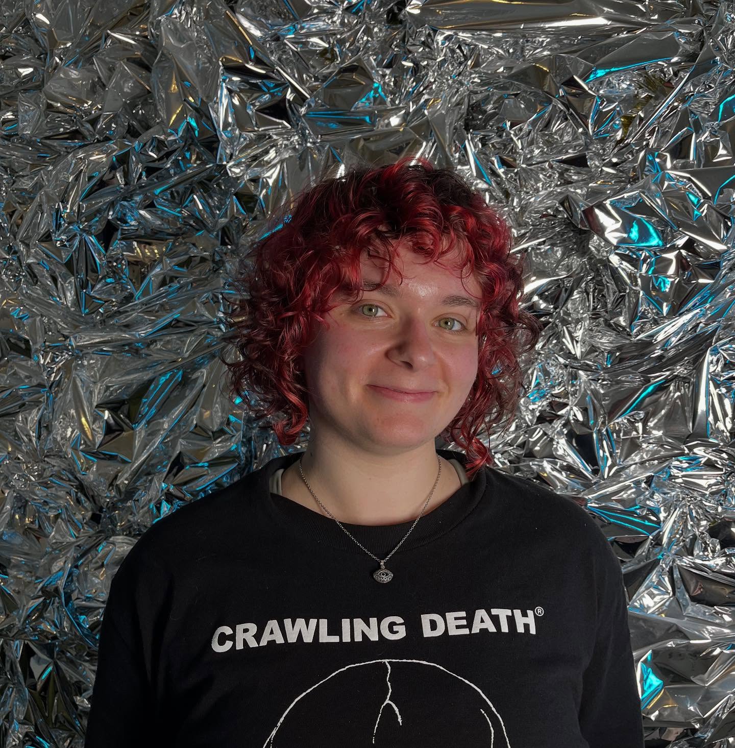 Vivid red curly bob with subtle highlights