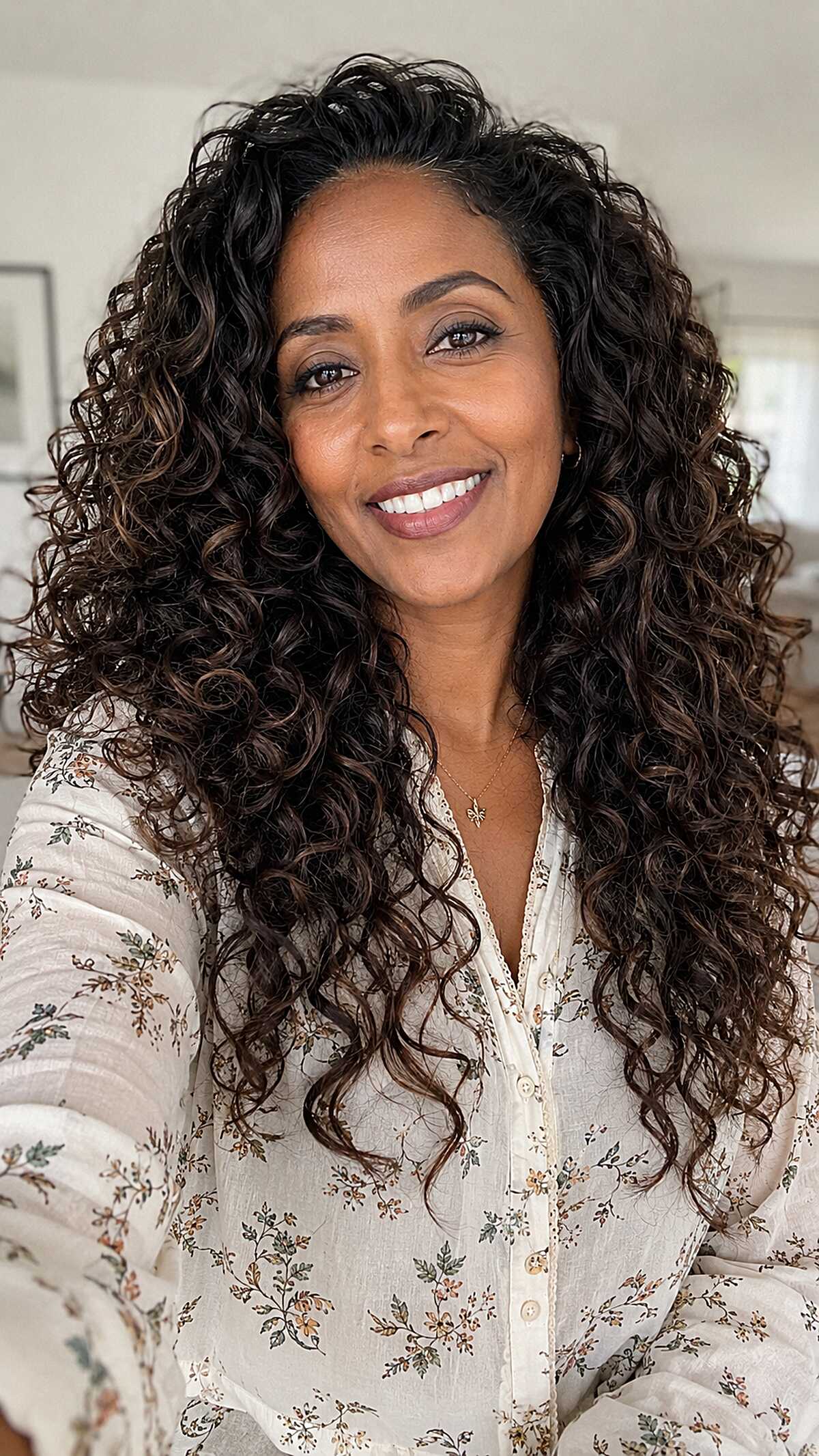 Caramel balayage through full natural curls brown highlights