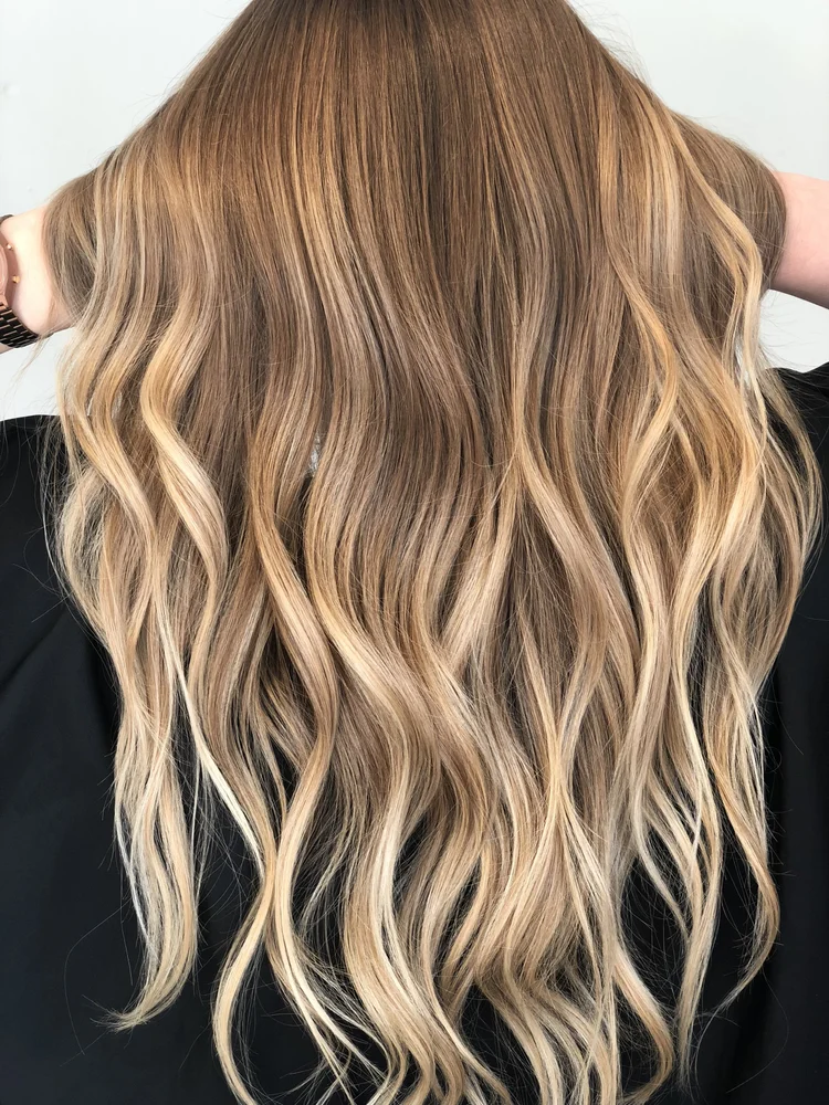 Waist-length golden blonde waves from salon