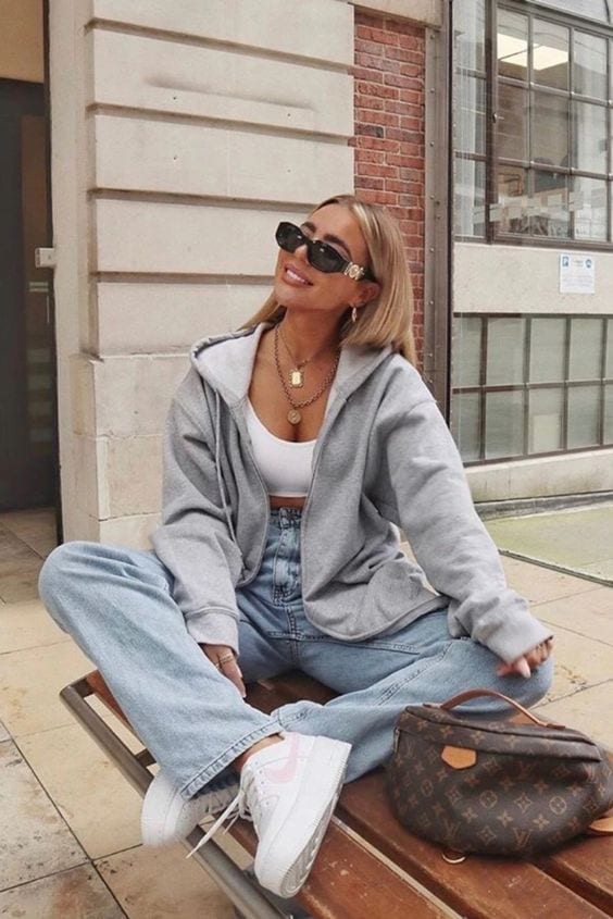 Grey Zip-Up Hoodie over a White Tank and Light-Wash Jeans streetwear outfit