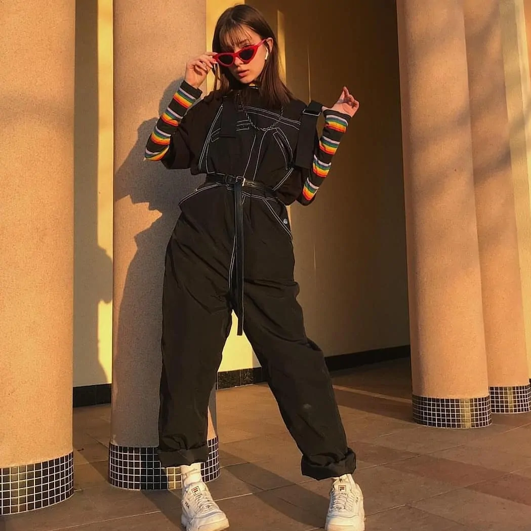 A Utility Jumpsuit With Rainbow Striped Sleeves edgy outfit