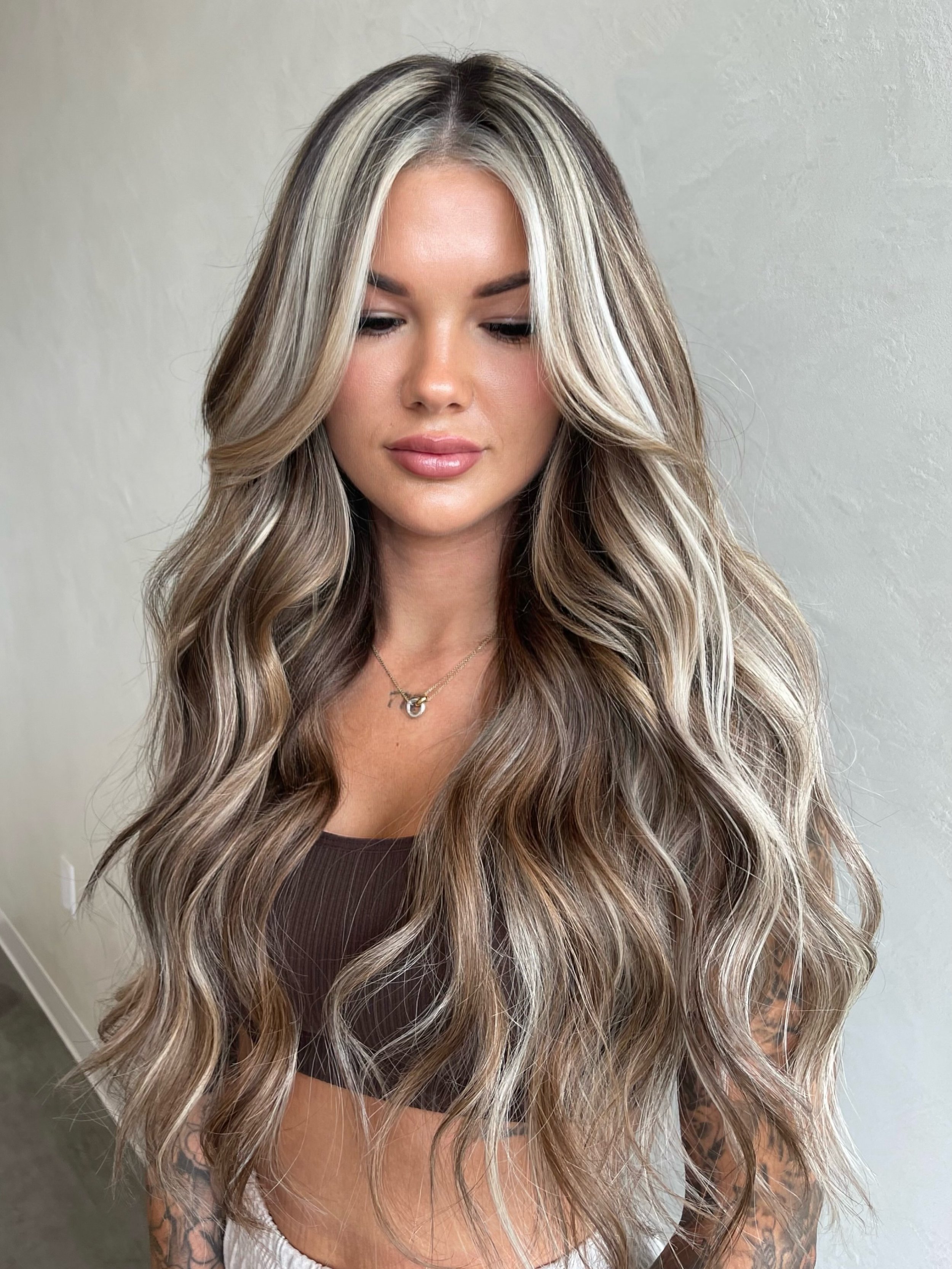 Ash blonde money piece highlights on wavy hair
