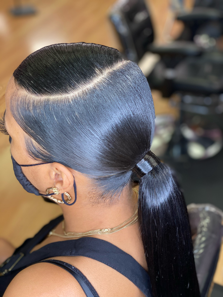 Prom hairstyle: sleek low ponytail with deep side part