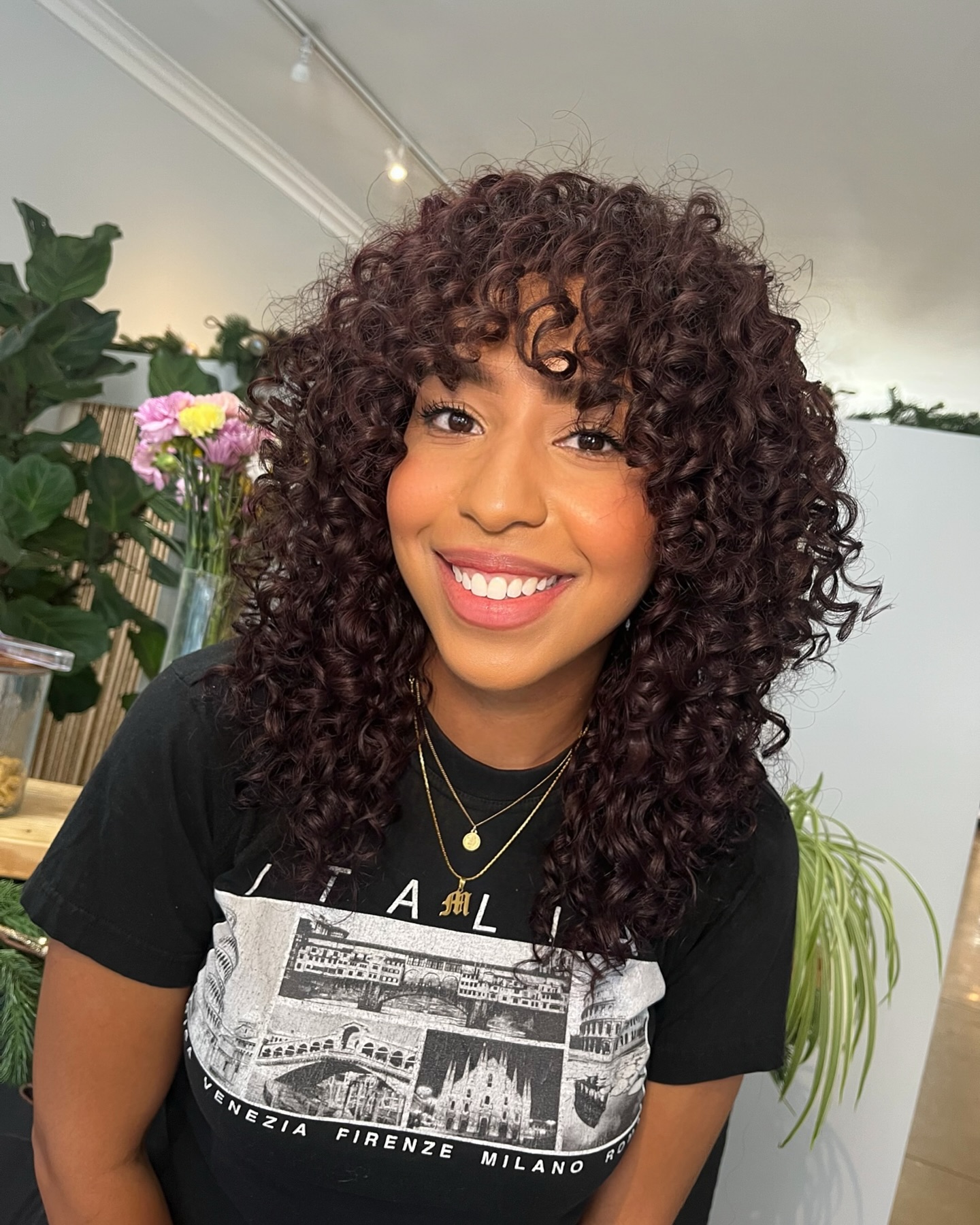 Bouncy layered curly cut with a curly fringe