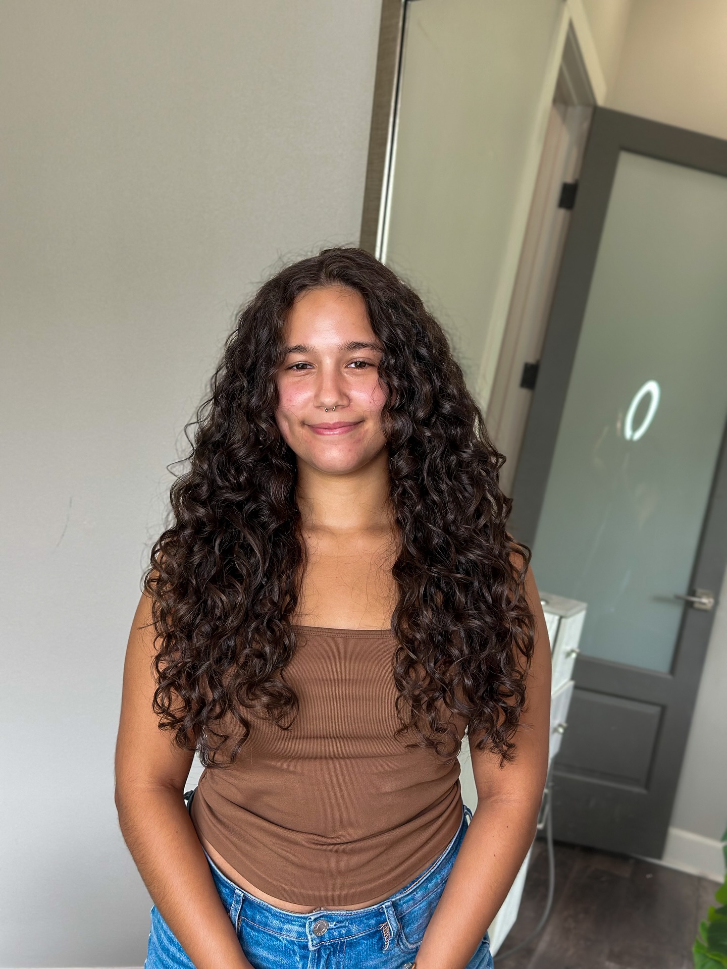 Mid-length curly cut with soft face-framing curls