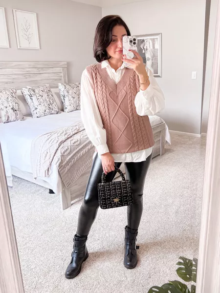 Cable-knit vest over a white shirt with leather leggings