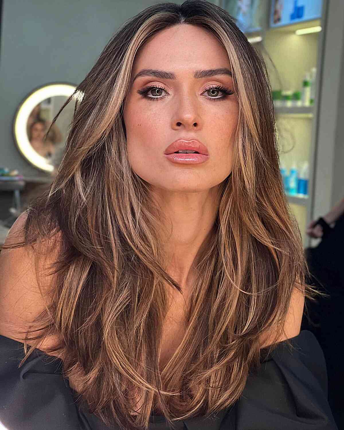 Long hair with a root shadow and soft blonde highlights