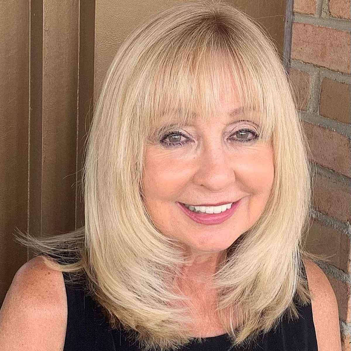 Long layers with feathered ends haircut for women over 60