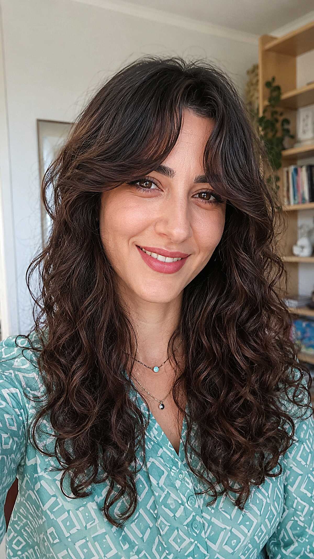 Loose spiral curtain bangs on dark brunette volume
