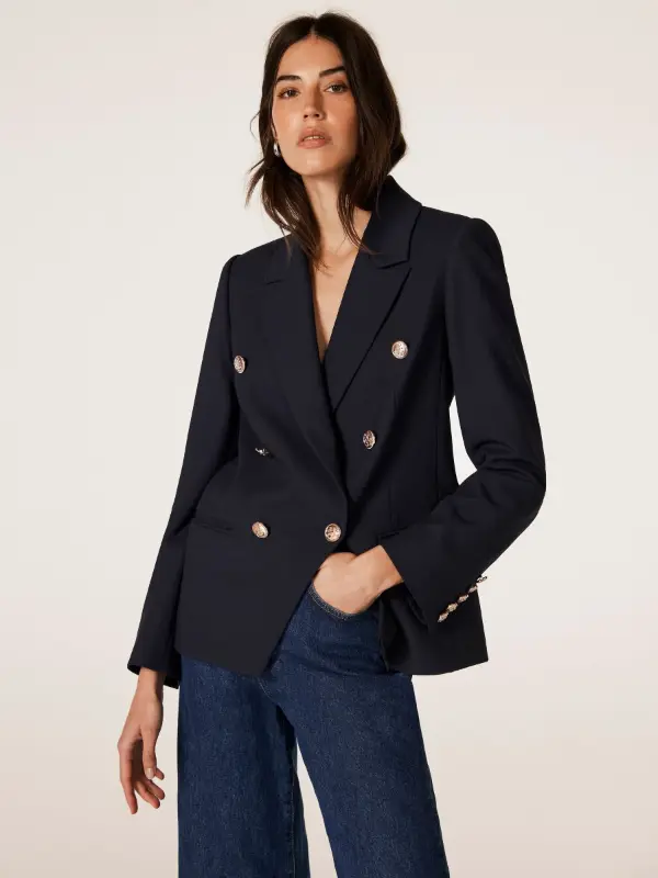 Double-breasted navy blazer with gold buttons and jeans