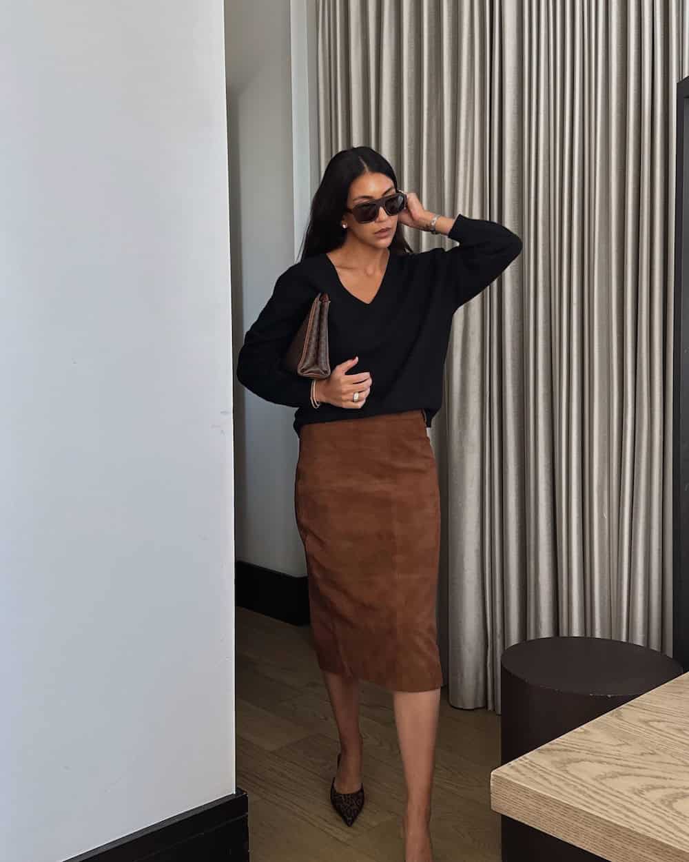 Brown suede pencil skirt with a black V-neck sweater work outfit