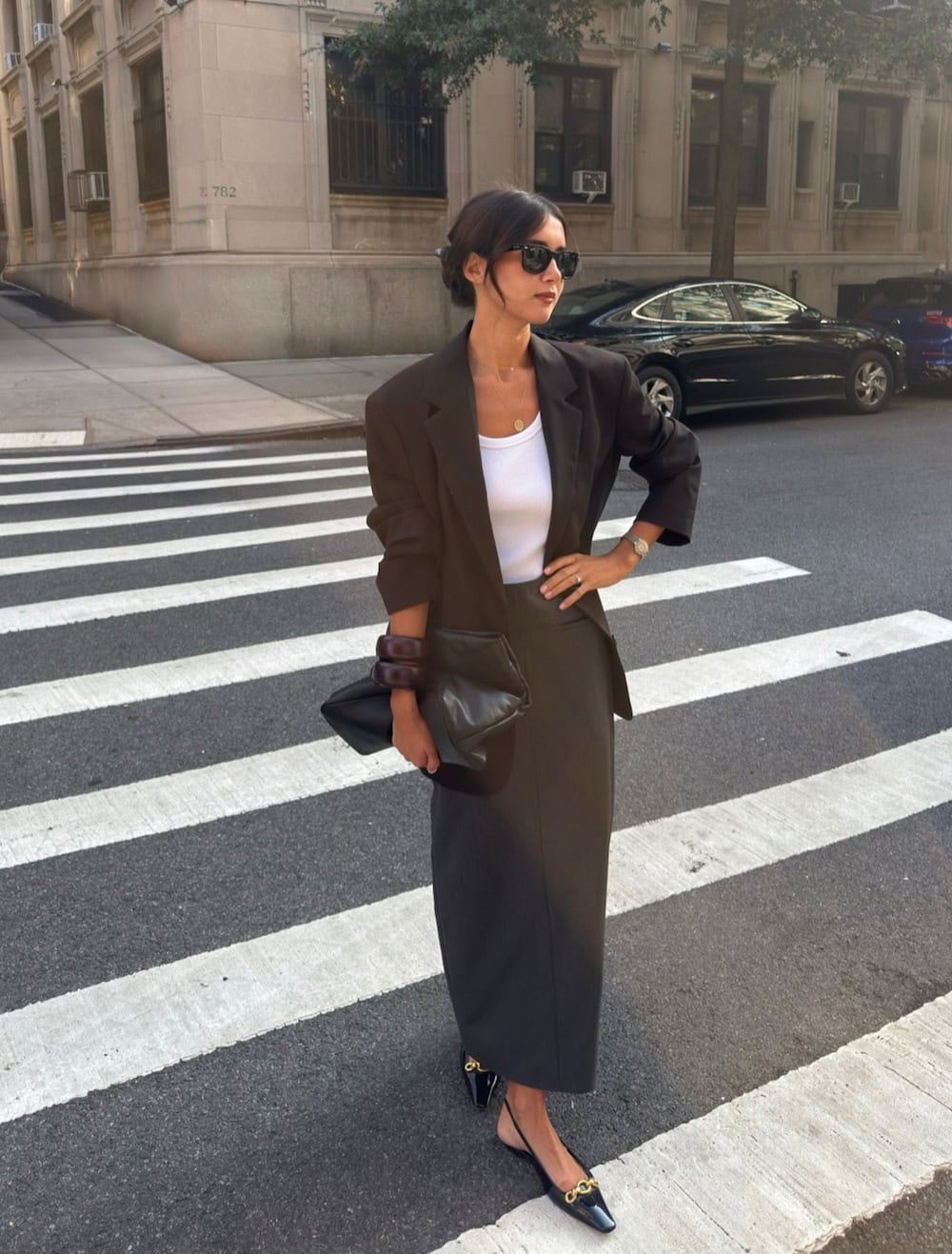 Dark green midi skirt with a white tank and dark brown blazer work outfit
