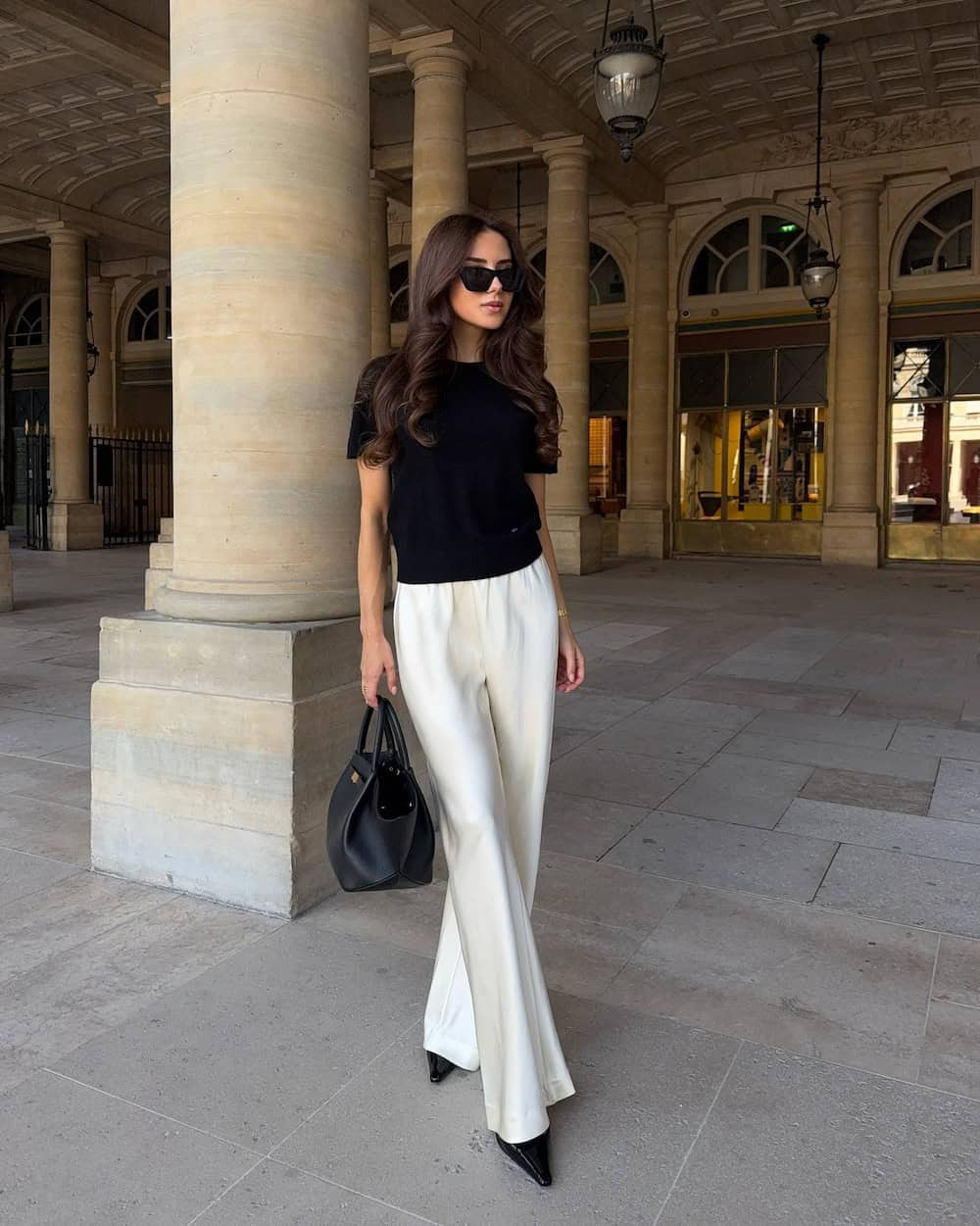 Silky white pants with a black short-sleeve top work outfit