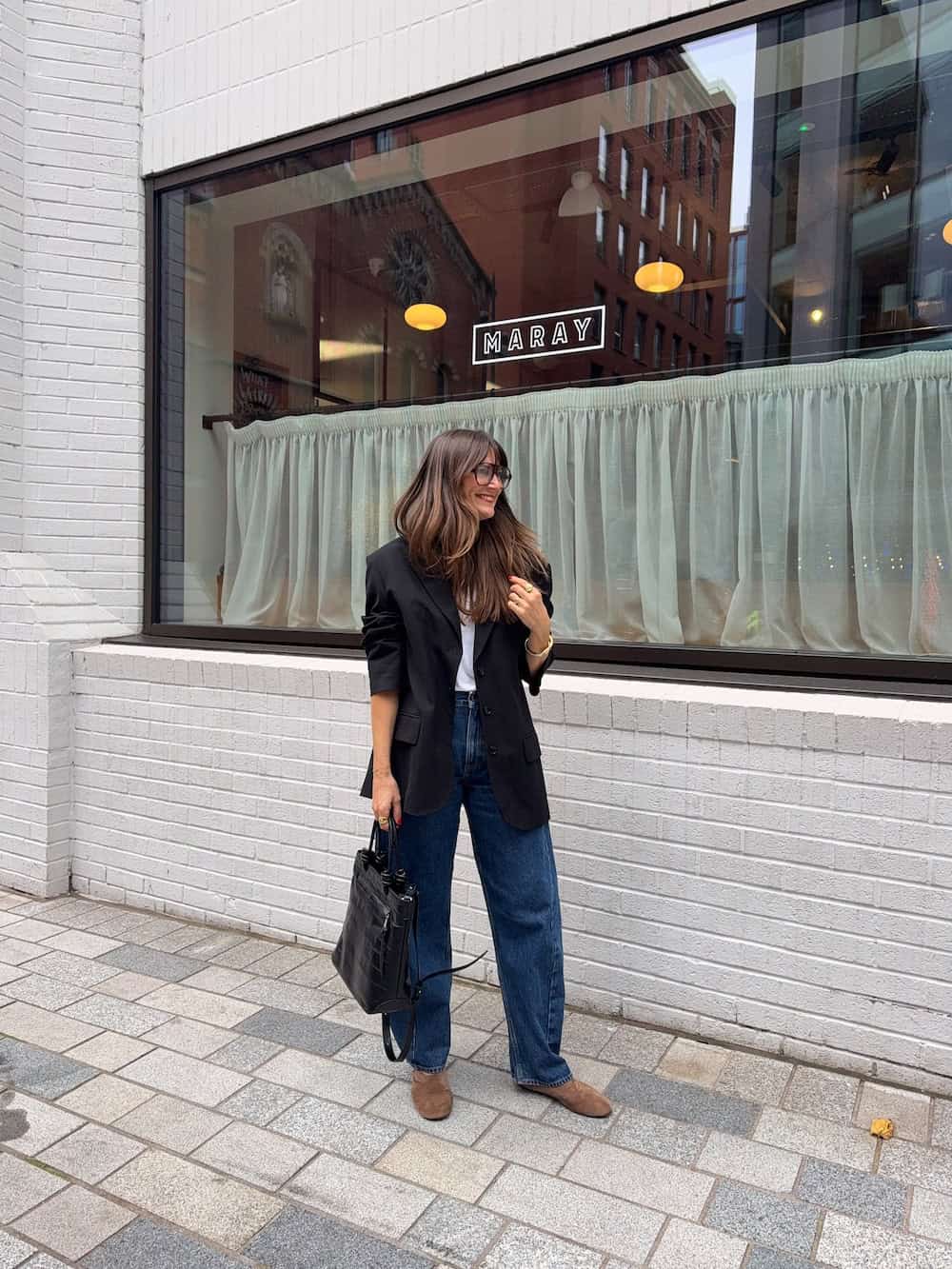 Blue jeans with a white tee and black blazer work outfit