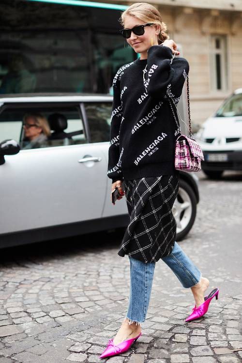 Bright mules with a dress layered over jeans