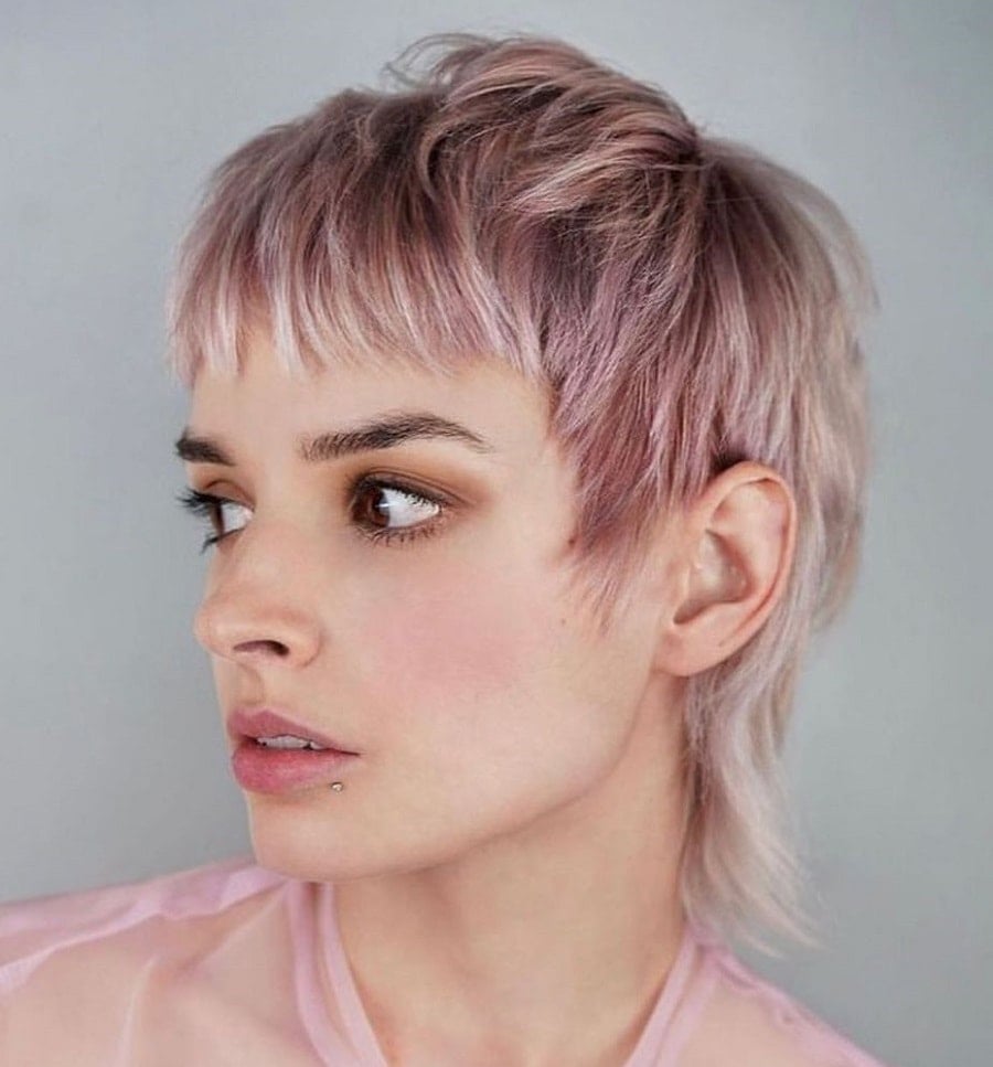 Woman with a mixie haircut blending mullet and pixie