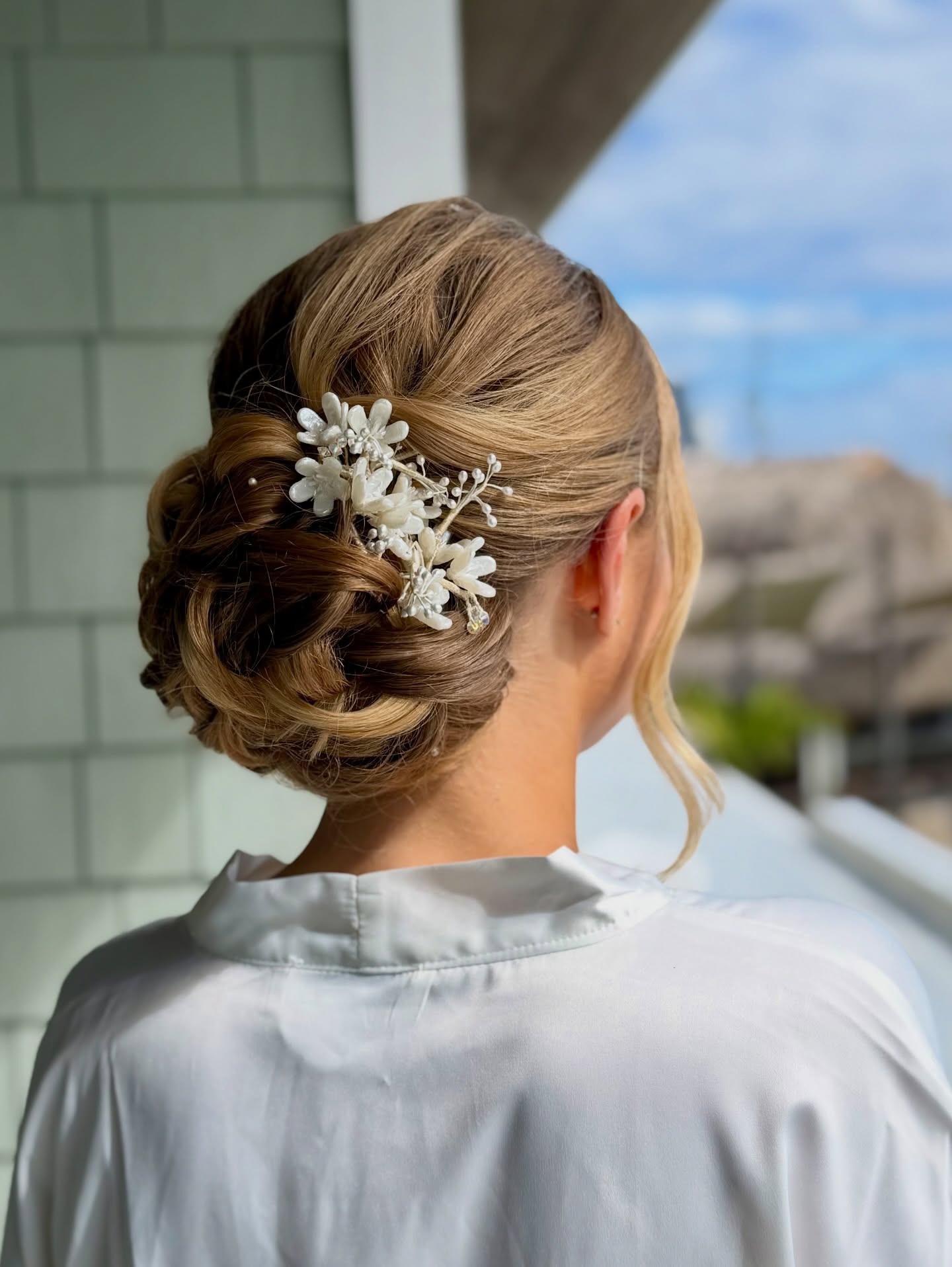 Romantic Low Chignon with Floral Accents hairstyle