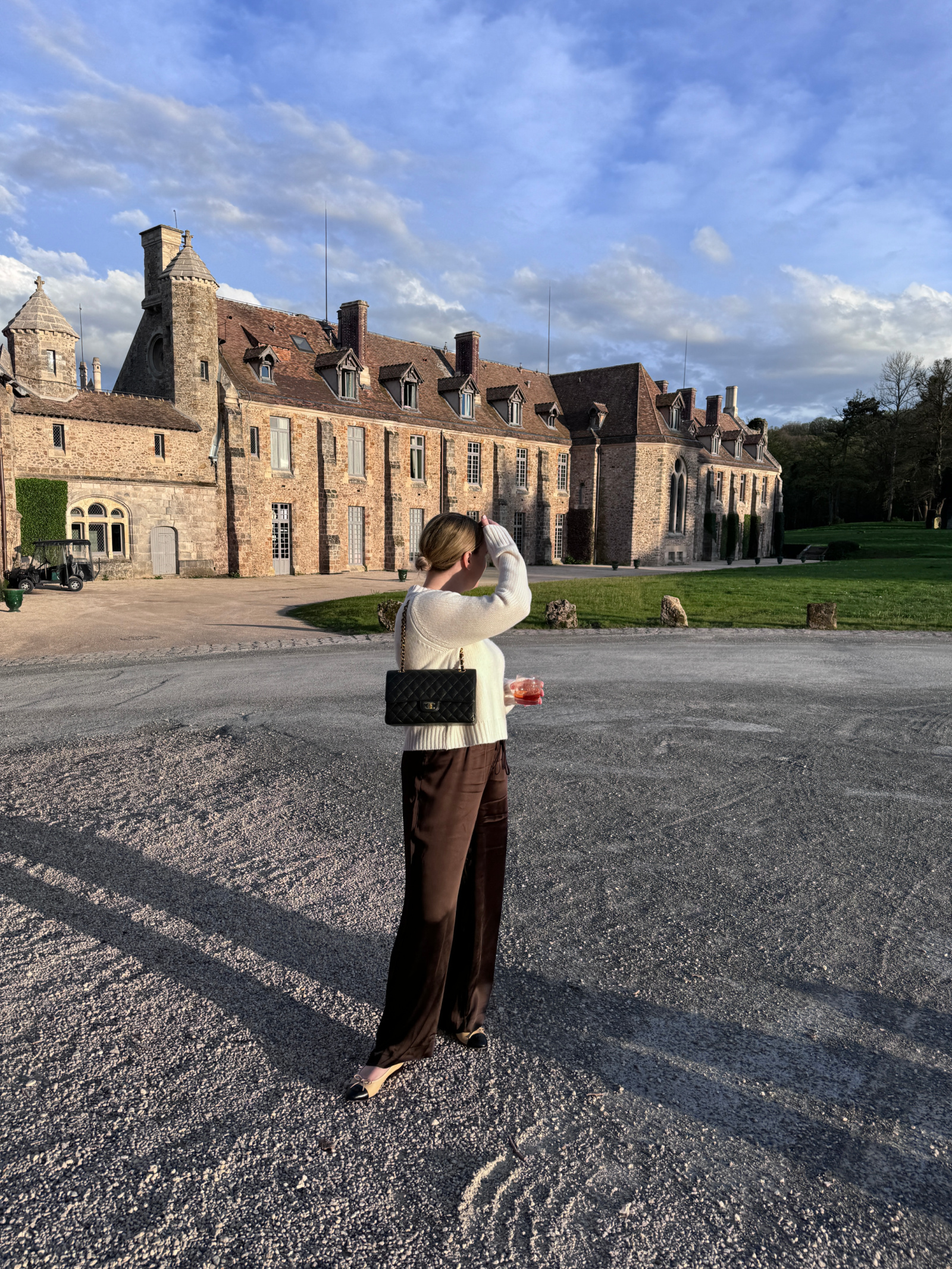 Woman wearing satin trousers with a cosy knit sweater LA outfit