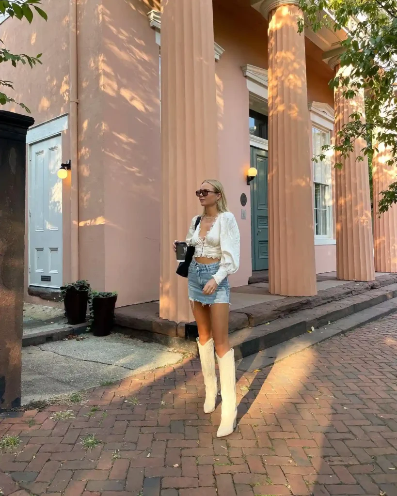 Ruffled crop blouse with denim mini skirt and cream cowboy boots