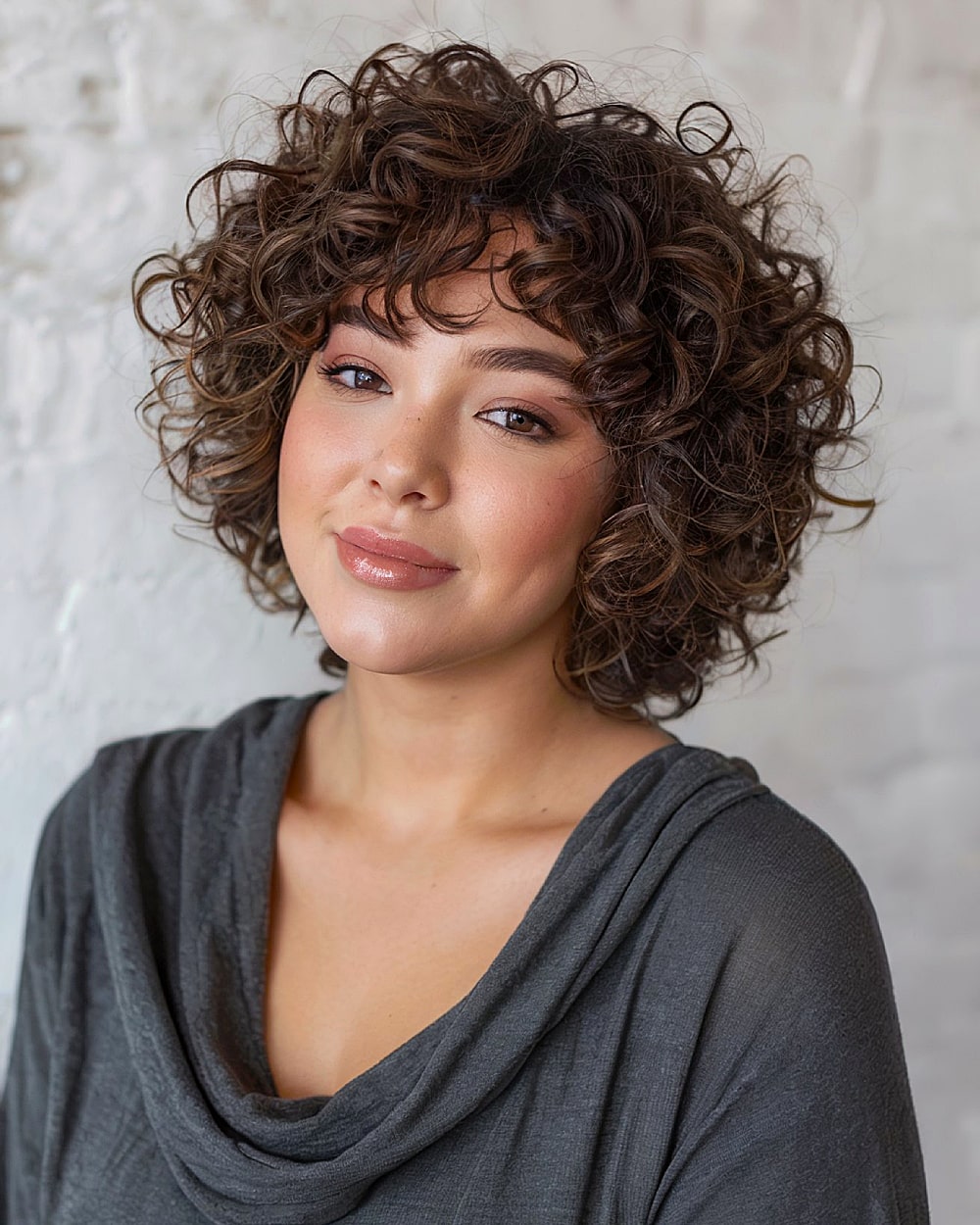 Feathered short curly hair with airy ends
