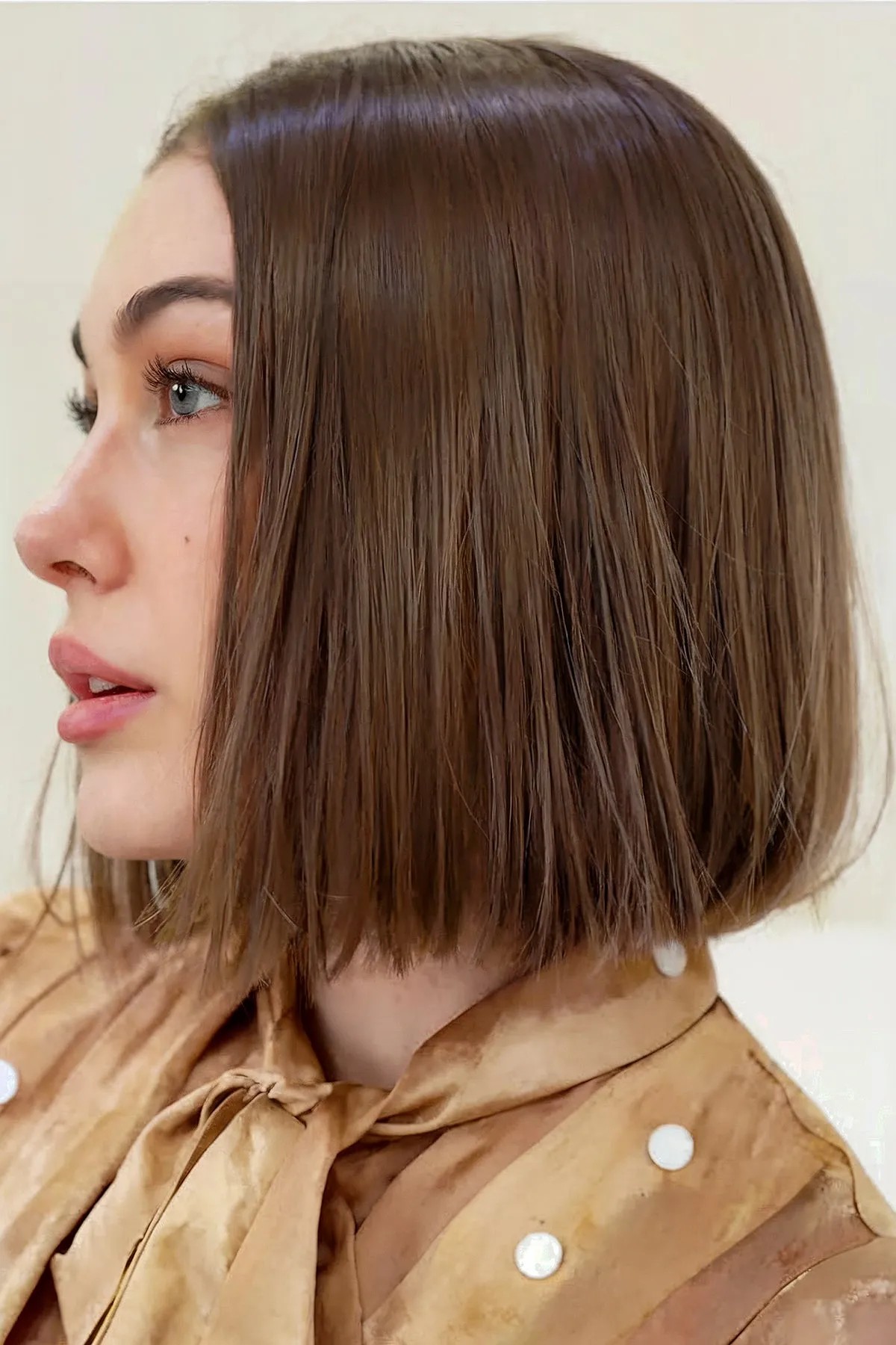 Short sleek box bob haircut with a middle part