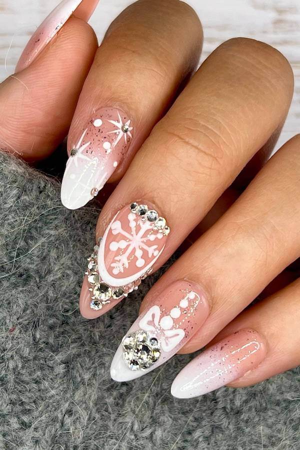 Ornate Snowflake Almond Nails With Rhinestones snowflake nail design