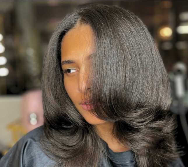 Straight layered hair with soft face-framing pieces, silk press finish