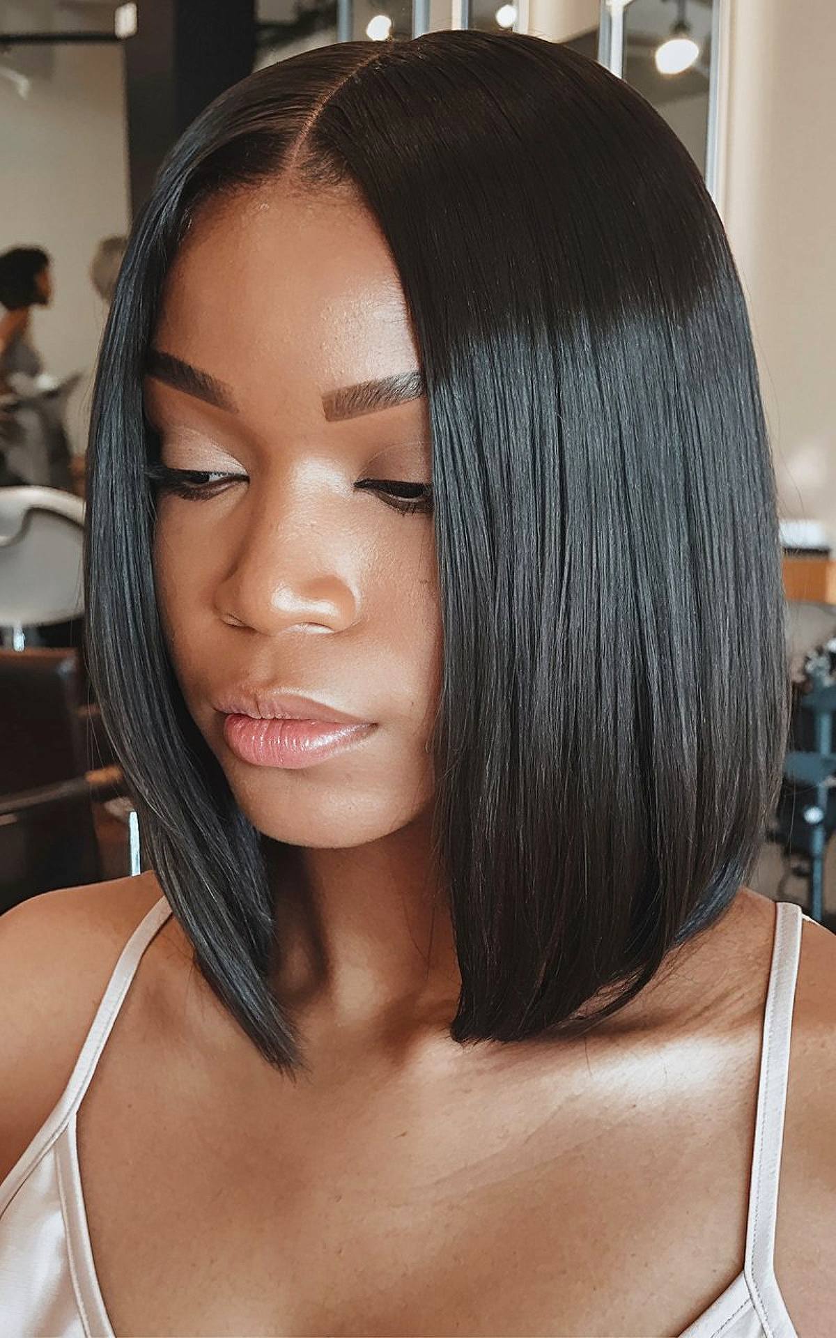 Jet-black bob with an asymmetrical angle silk press hairstyle