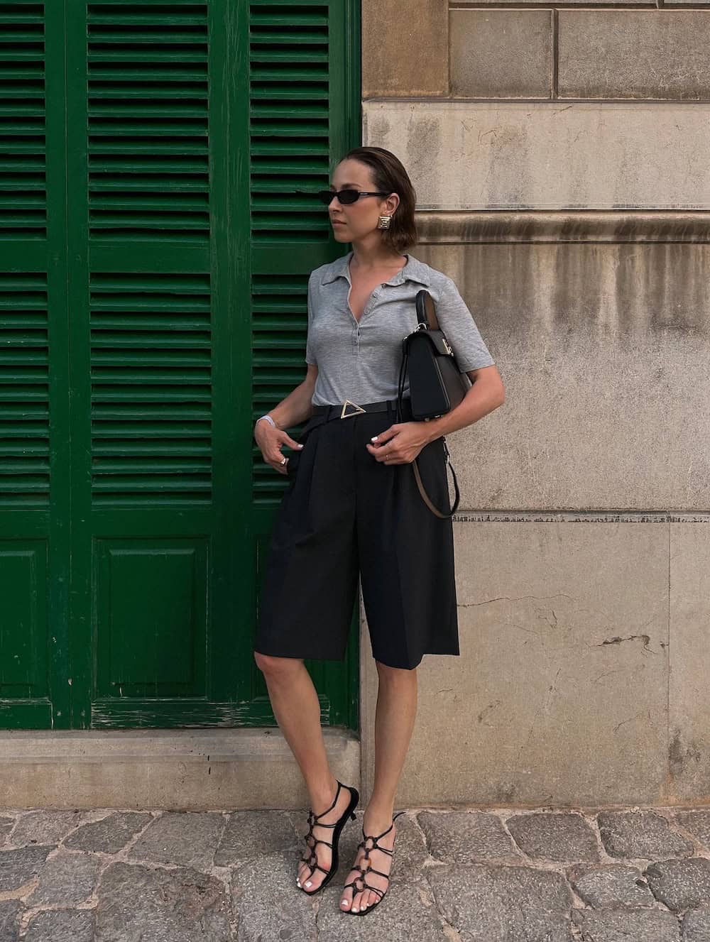 Black Bermuda shorts with a slim shirt and kitten heel sandals work outfit