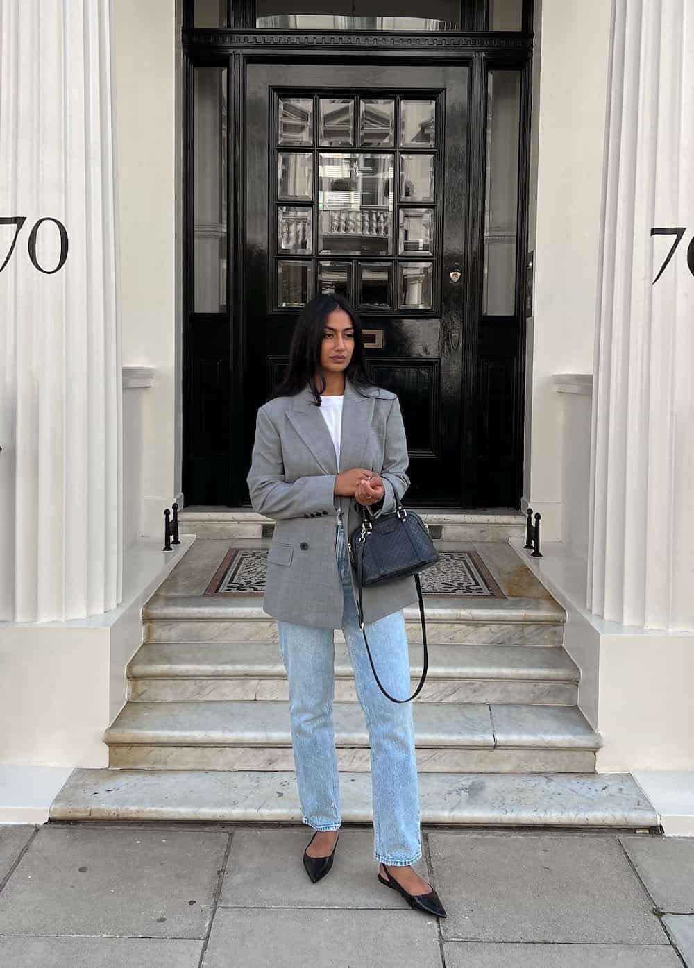 Light-wash jeans with a white tee and oversized blazer work outfit