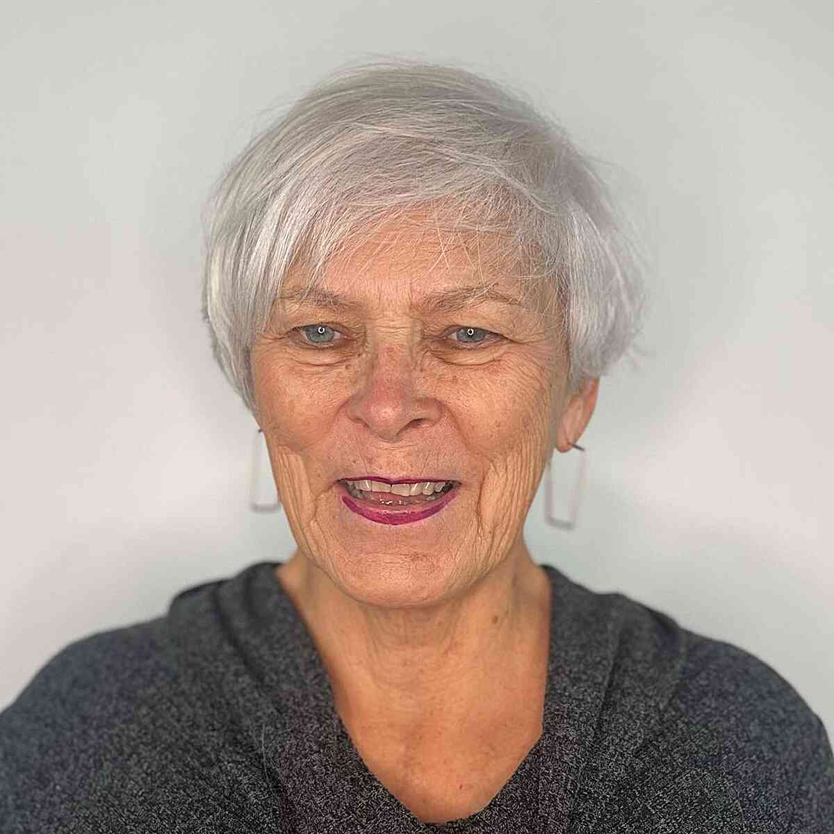 Side-swept pixie on thin white hair haircut for women over 60