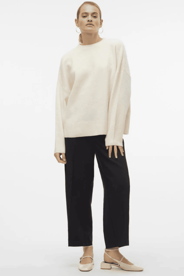 Oversized cream crewneck sweater with black cropped trousers