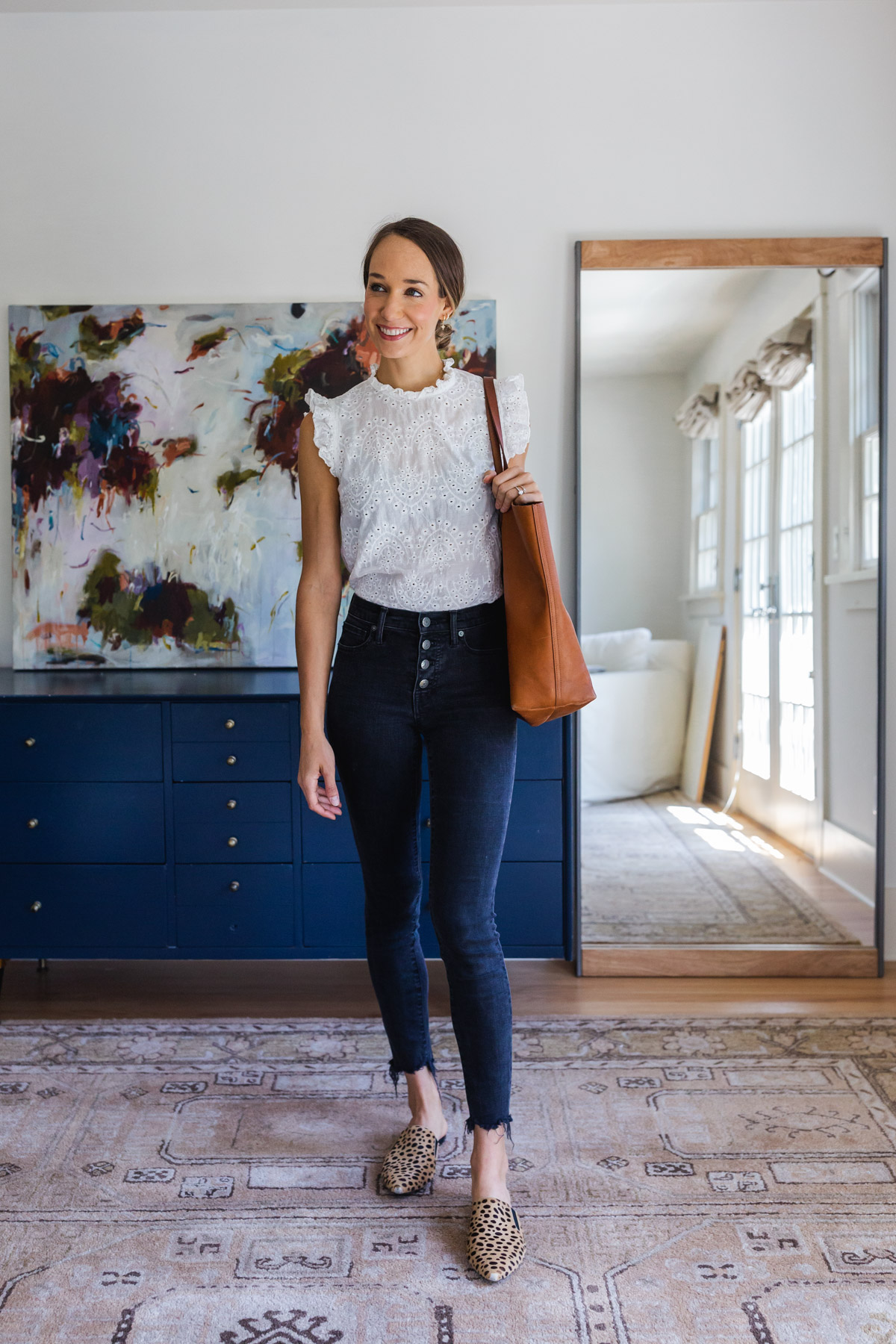 White eyelet top with black skinny jeans and leopard mules